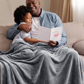 Bedsure GentleSoft fleece blanket draped over a sofa for quick couch comfort.