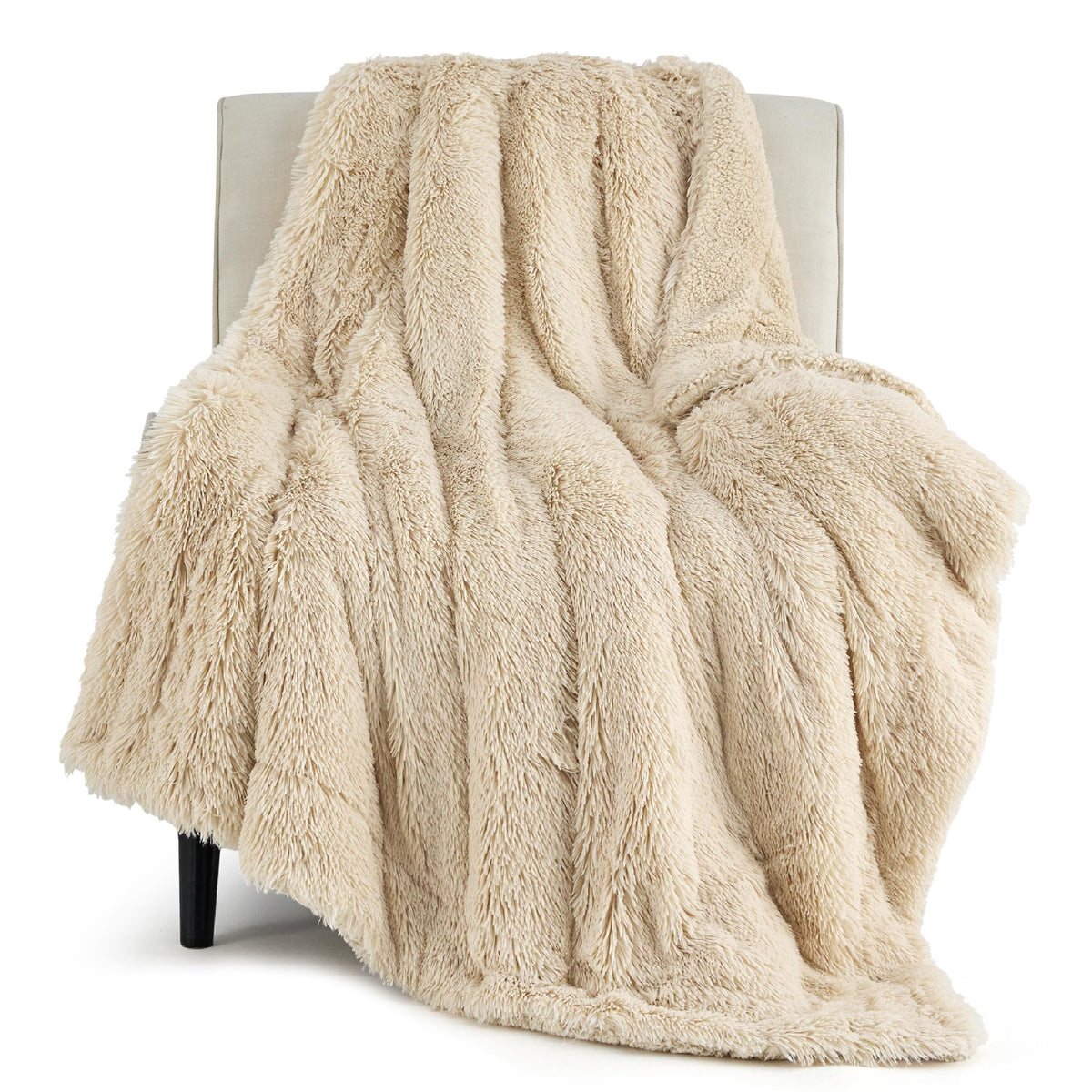 Bedsure GentleSoft fluffy beige throw on bed for warm, cozy evenings.