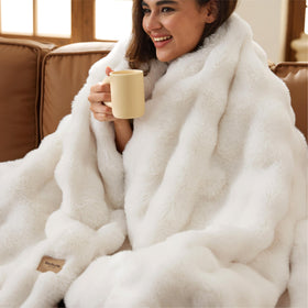 Bedsure GentleSoft fluffy faux fur throw on sofa for cloud-like comfort.