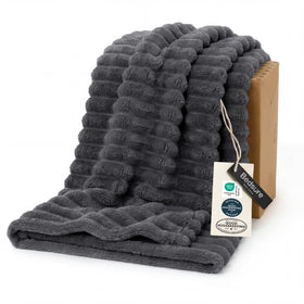 Bedsure GentleSoft grey fleece blanket on a couch for cozy relaxation.