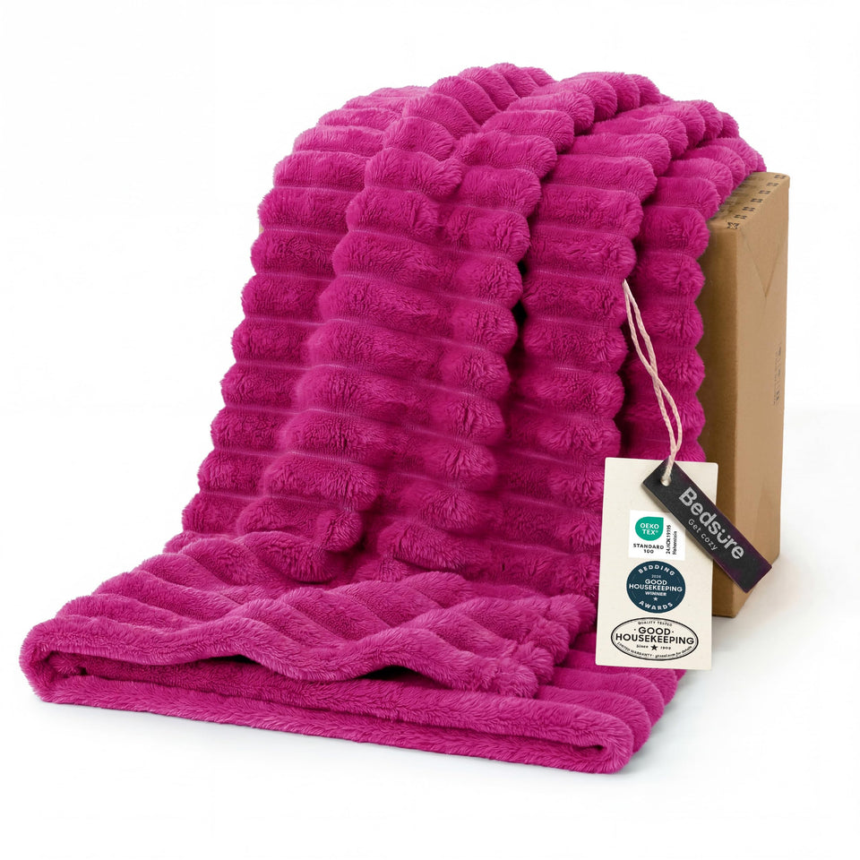 Bedsure GentleSoft hot pink throw on couch for cozy evenings.