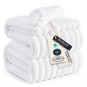 Bedsure GentleSoft king throw blanket on sofa showing striped fleece texture for cozy lounging.