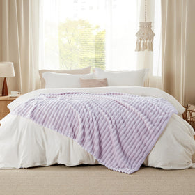 Bedsure GentleSoft Lavender Fog Throw layered with pillows creates soft inviting ambiance