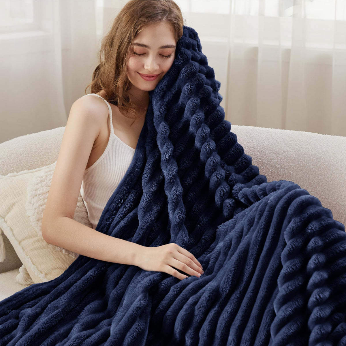 Bedsure GentleSoft navy-blue blanket folded neatly, ready for quick warmth.