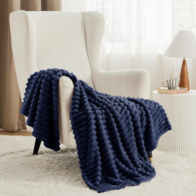 Bedsure GentleSoft navy-blue blanket on couch demonstrates versatile, comforting use.