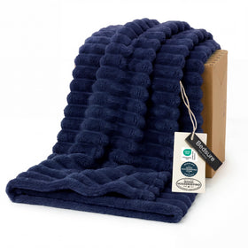 Bedsure GentleSoft navy blue fleece blanket on couch offering cozy warmth for evenings