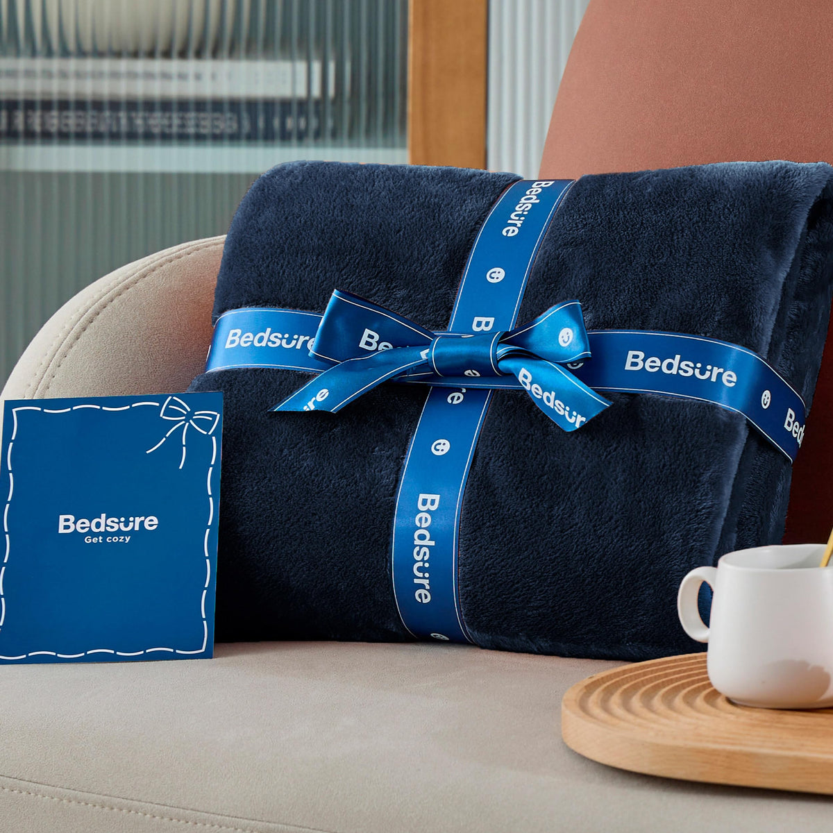 Bedsure GentleSoft navy fleece blanket draped over chair for versatile use