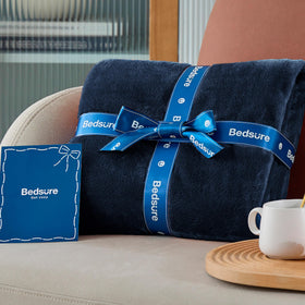 Bedsure GentleSoft navy fleece blanket draped over chair for versatile use