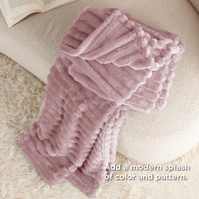 Bedsure GentleSoft pink fleece blanket beside TV for cozy binge nights