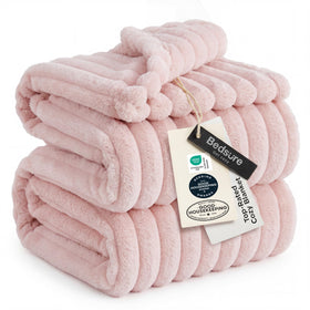 Bedsure GentleSoft Pink Throw on sofa provides cozy warmth for relaxing evenings.