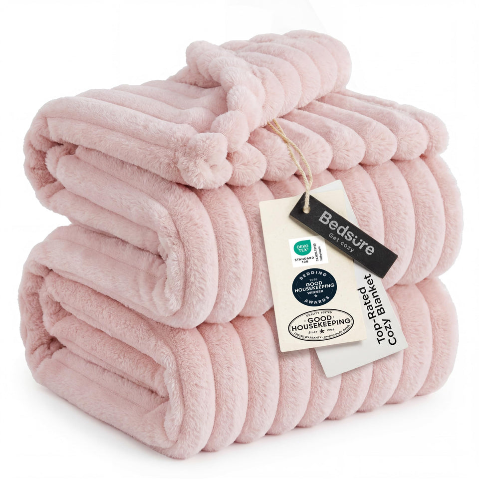 Bedsure GentleSoft Pink Throw on sofa provides cozy warmth for relaxing evenings.