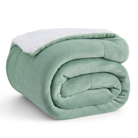 Bedsure GentleSoft sherpa blanket on sofa in sage green for cozy lounging.