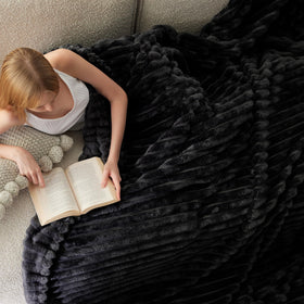 Bedsure GentleSoft model snuggling with blanket shows cozy, stylish comfort.