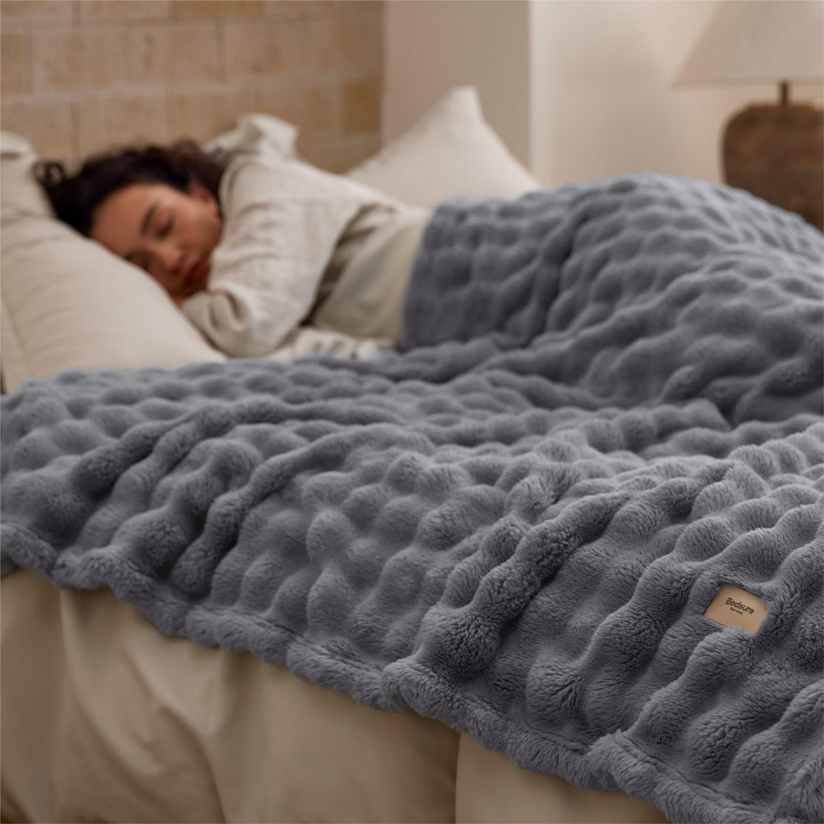 Bedsure grey throw draped on bed adds subtle texture and style.