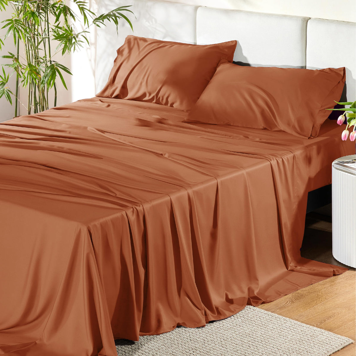 Bedsure king bamboo sheets flat lay with silky texture and burnt orange color.