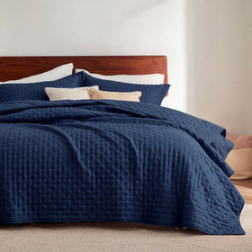 Bedsure king quilt in navy blue with embossed clover pattern for a modern bedroom look