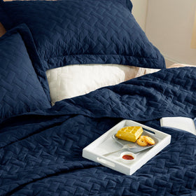 Bedsure king quilt with two shams ready to complete the bed setup.