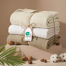 Bedsure muslin throw in a white bedroom setup for a clean, airy ambience.