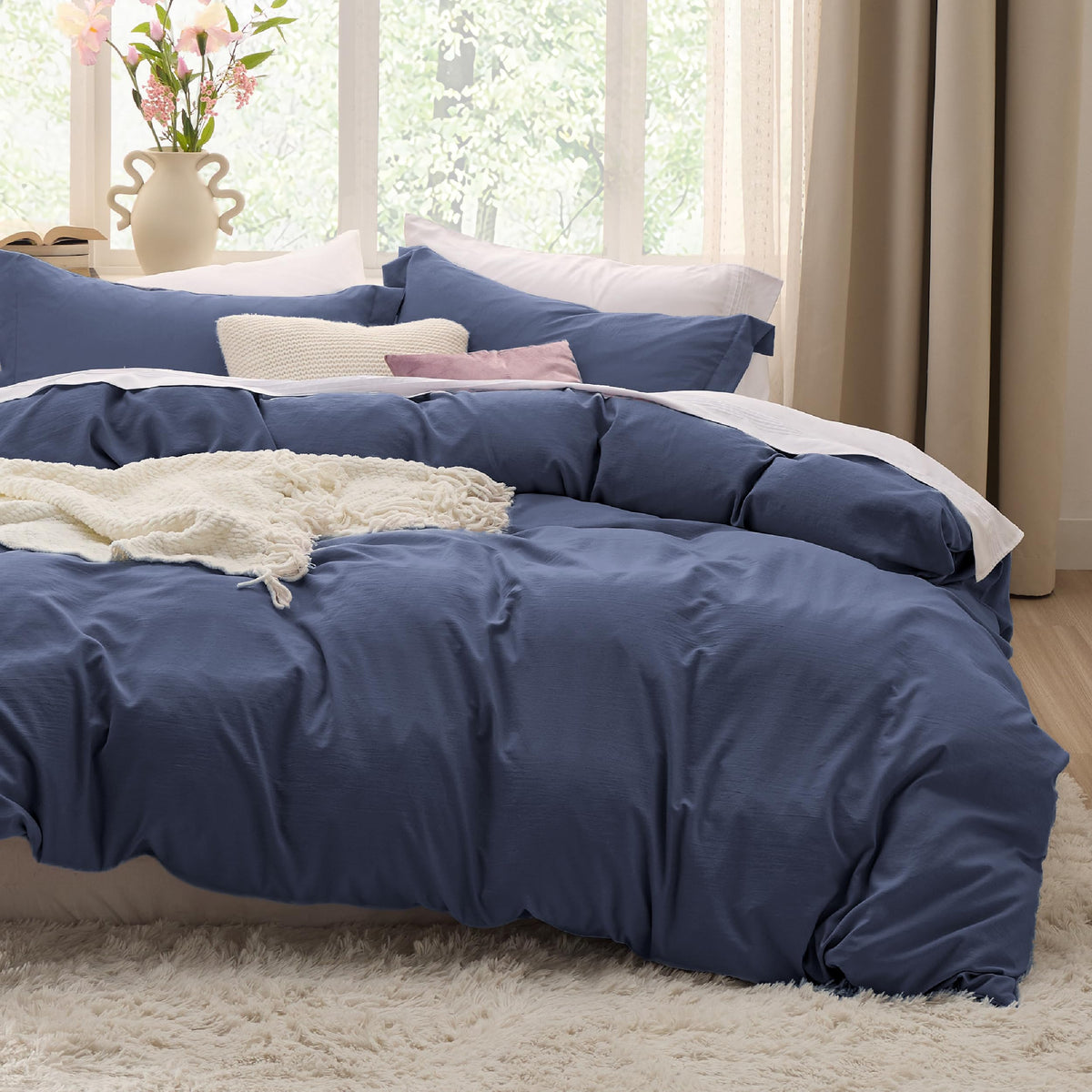Bedsure navy blue duvet cover 68x90 inches on twin/twin XL beds with a soft, cotton-like touch.