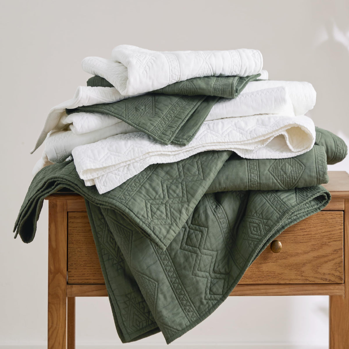 Bedsure olive green quilt on nightstand with lamp, cozy ambiance