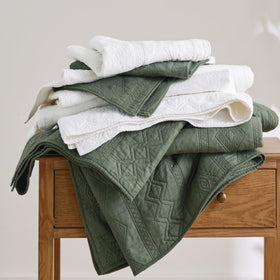 Bedsure olive green quilt on nightstand with lamp, cozy ambiance
