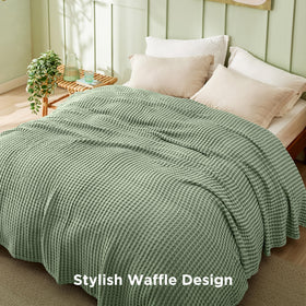 Bedsure sage-green blanket draped over a sofa, adding texture and color.