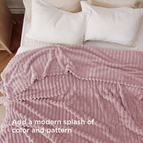 Bedsure striped pink blanket texture complements modern room decor.
