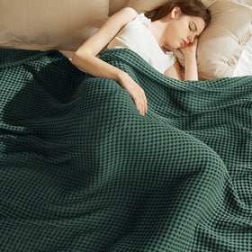 Bedsure waffle blanket on bed in dark green, breathable comfort.
