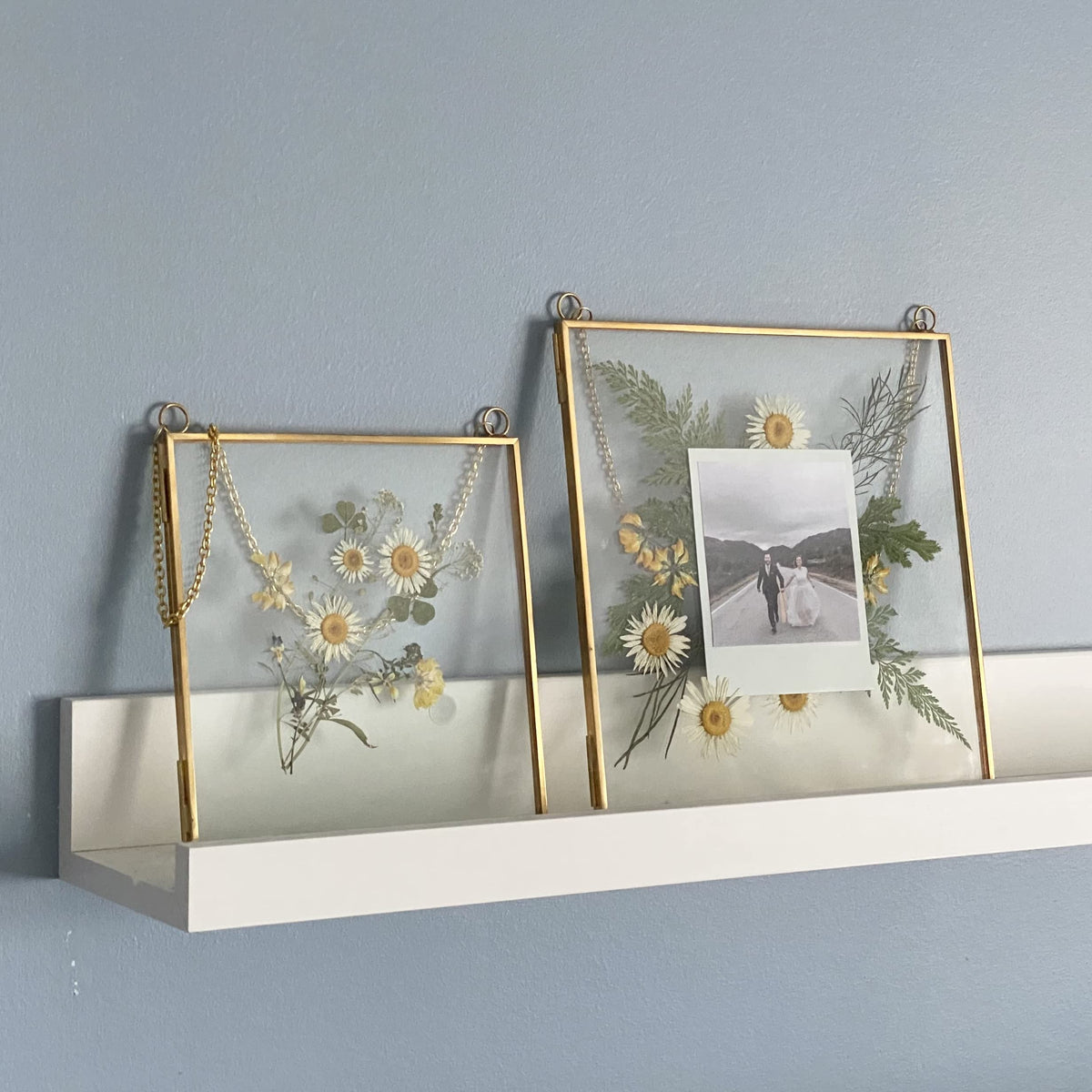 Beedecor glass frame with brass chain adds versatile display options.