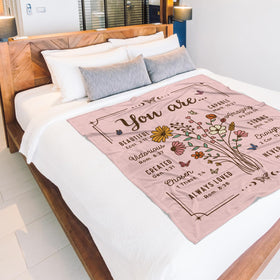 BeneCharm blanket draped over bed for cozy mornings.