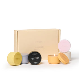 Benevolence LA candle gift set with six tins displayed for gifting and cozy ambiance