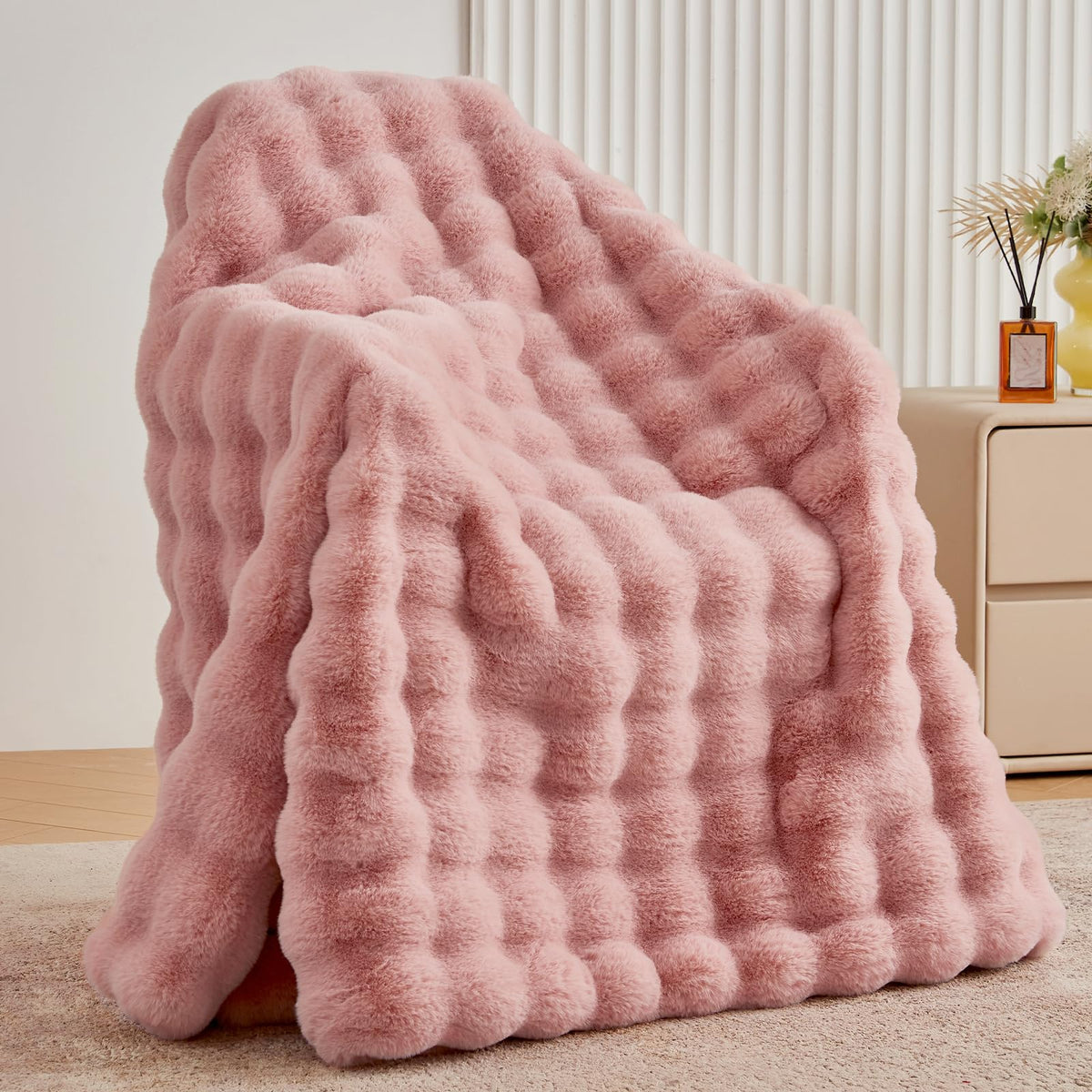 BENVWE dusty pink faux fur throw blanket on a couch for cozy warmth.