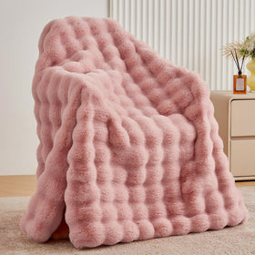 BENVWE dusty pink faux fur throw blanket on a couch for cozy warmth.