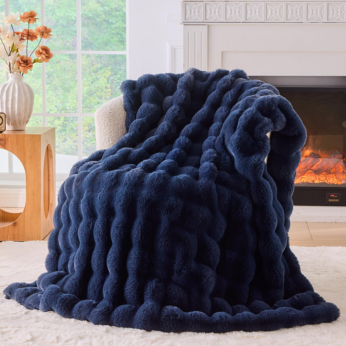 BENVWE fluffy faux fur throw blanket on a navy couch for luxurious warmth