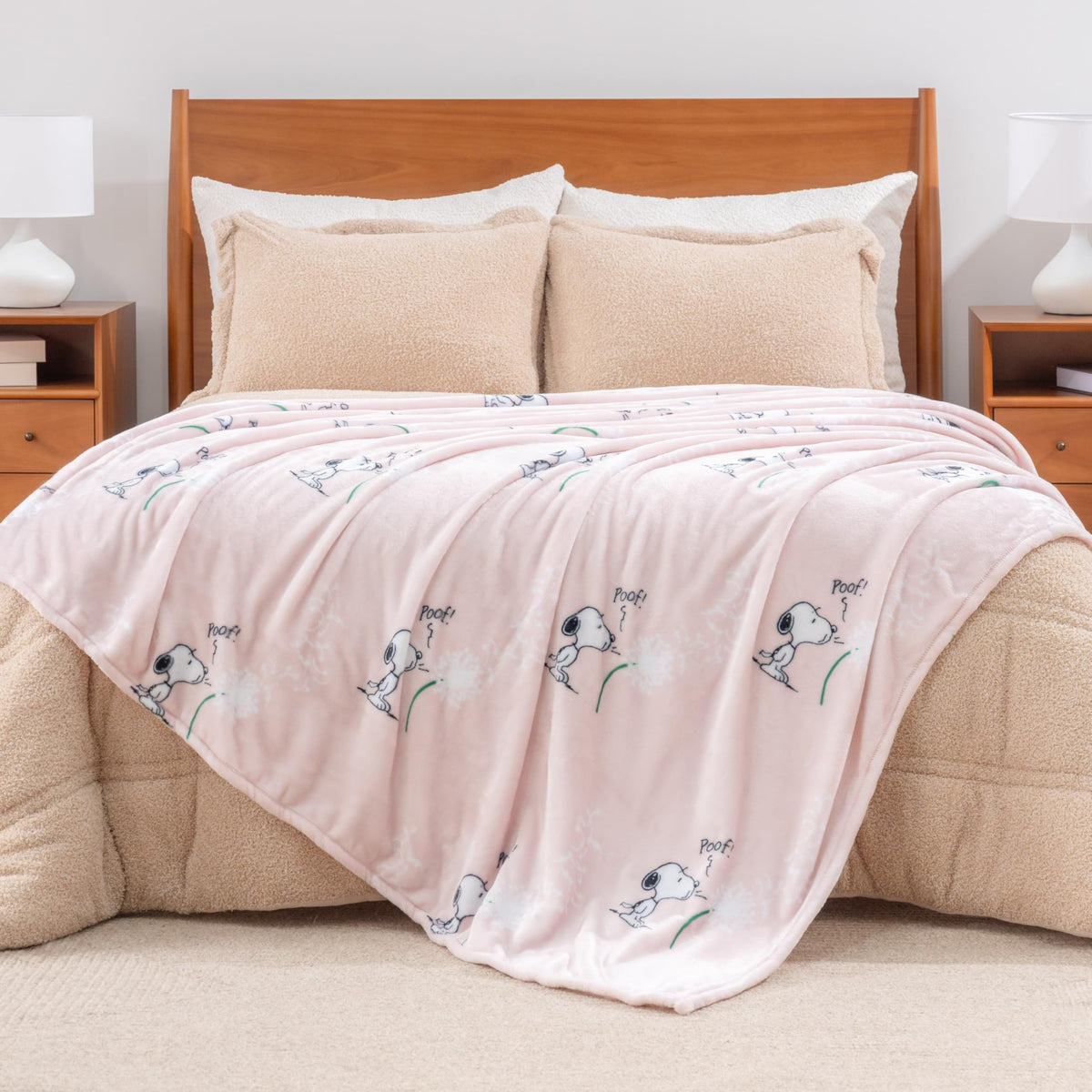 Snoopy-themed blanket draped over a chair in a modern living room.