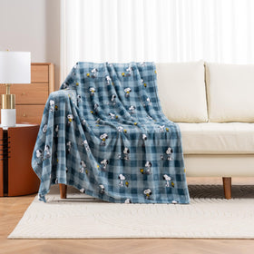 Berkshire Blanket Peanuts VelvetLoft Snoopy character image on navy plaid throw.