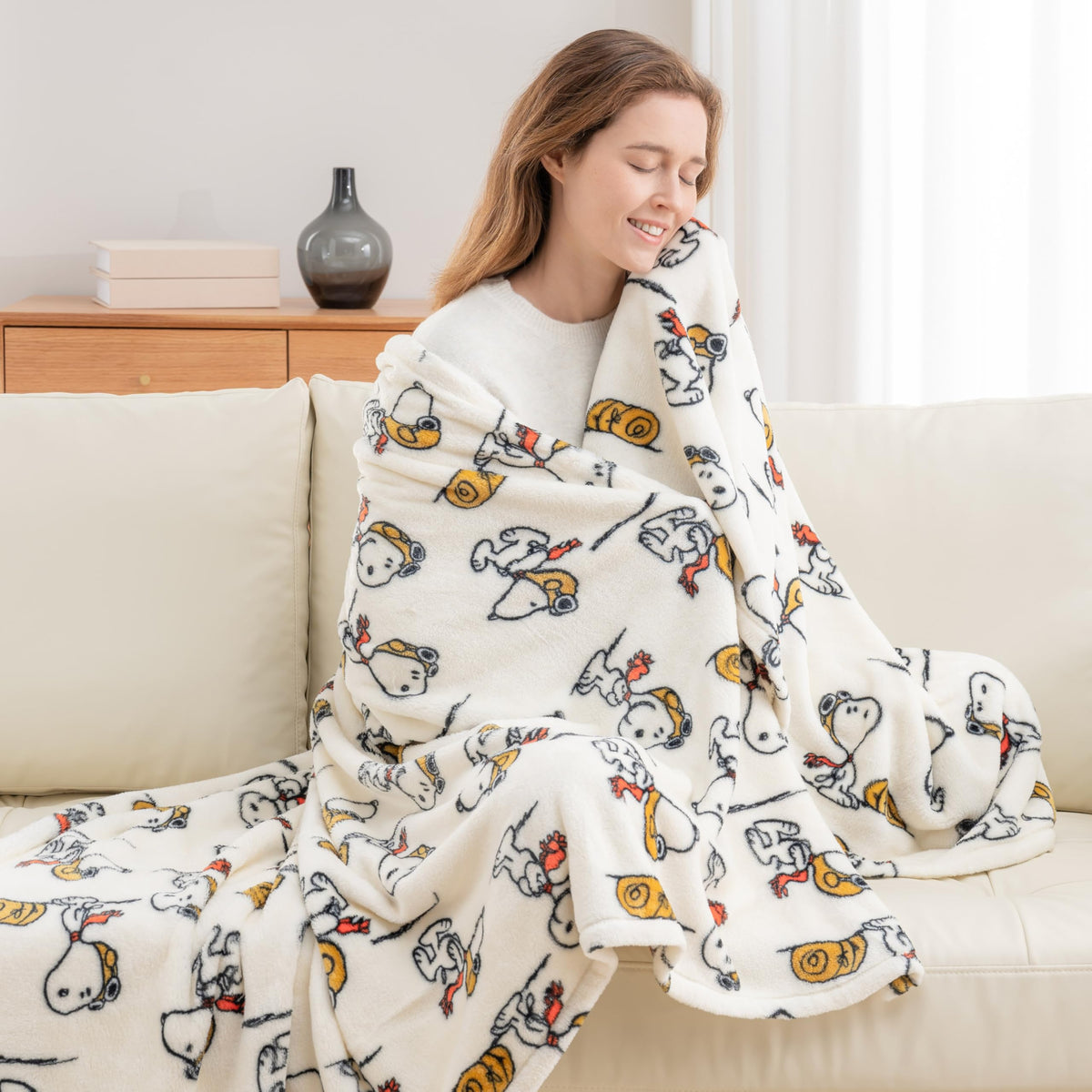 Berkshire Blanket Peanuts VelvetLoft Snoopy throw on sofa for family movie nights