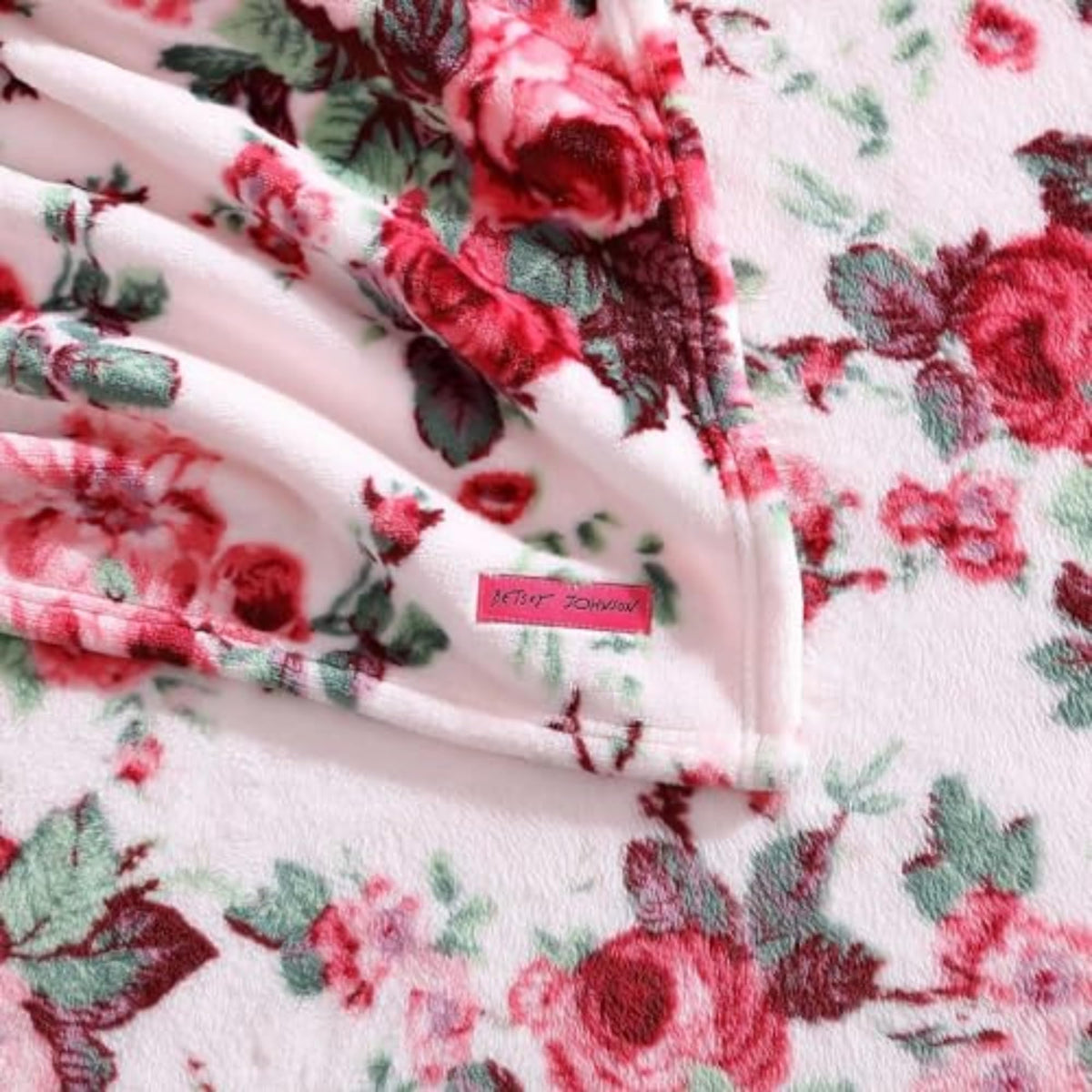 Betsey Johnson blanket 50x70 dimension demonstrates ample wrap for sofa or bed.