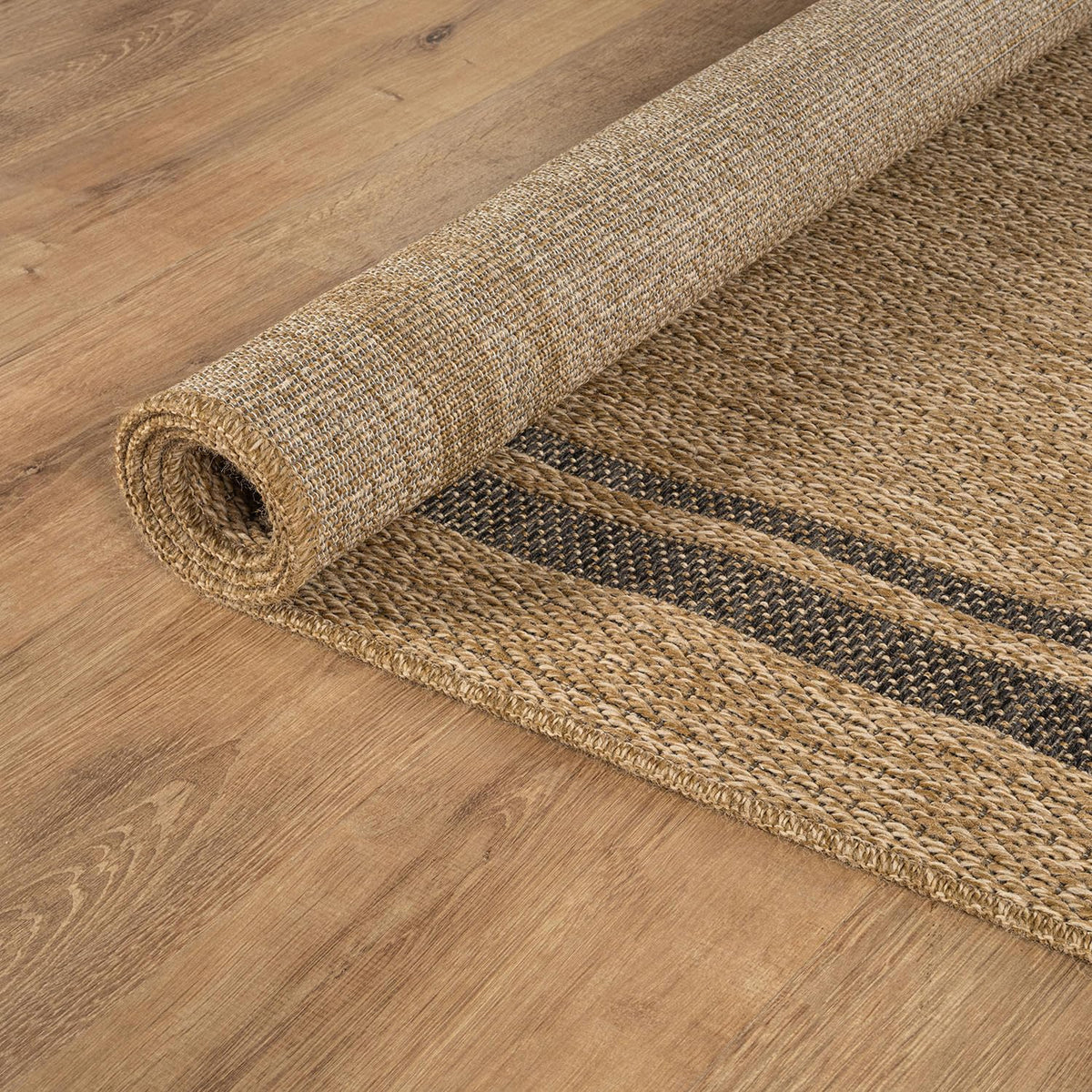 Beverly Rug Easy Jute Border Rug 5x7 shown behind sofa with rug durability.