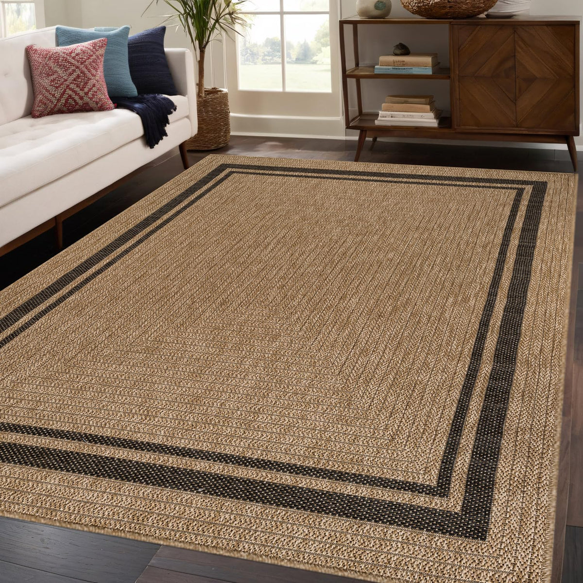 Beverly Rug Easy Jute Border Rug 5x7 on patio for casual outdoor use.