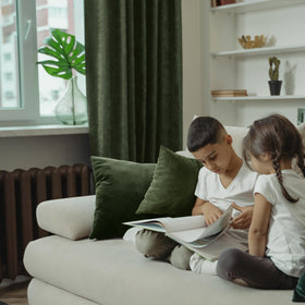 BGment olive green velvet drapes in darker room, noticeable light control and cozy ambience.