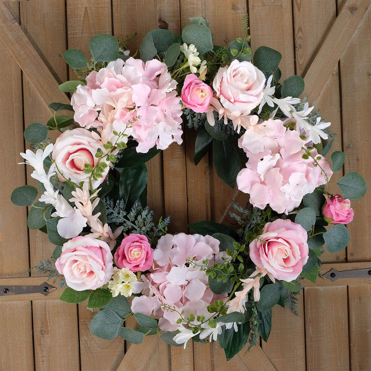 Bibelot wreath shows silk roses and eucalyptus leaves for elegant detail.