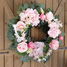 Bibelot pink rose wreath features hydrangea accents for soft decor.