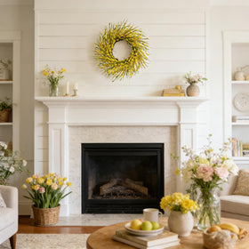 Bibelot Forsythia wreath on fireplace mantel adds seasonal charm.