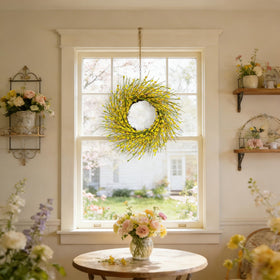 Bibelot Forsythia wreath as window decor brightens the view.