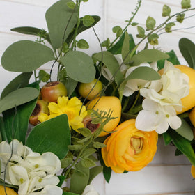 Bibelot lemon wreath enhances festive front-door display and party ambiance.
