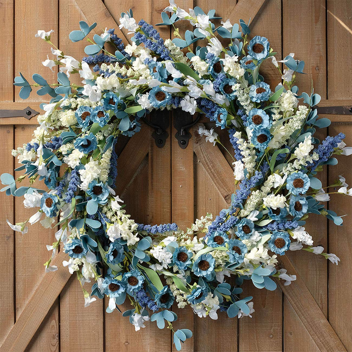 Bibelot spring wreath on front door with blue-green accents.