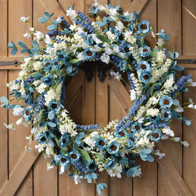 Bibelot spring wreath on front door with blue-green accents.
