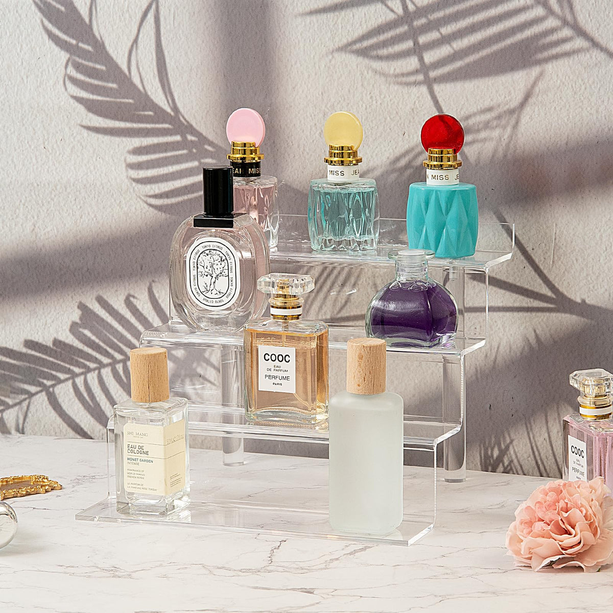 Bigantss display shelf showcasing perfume and toys on a tiered stand.