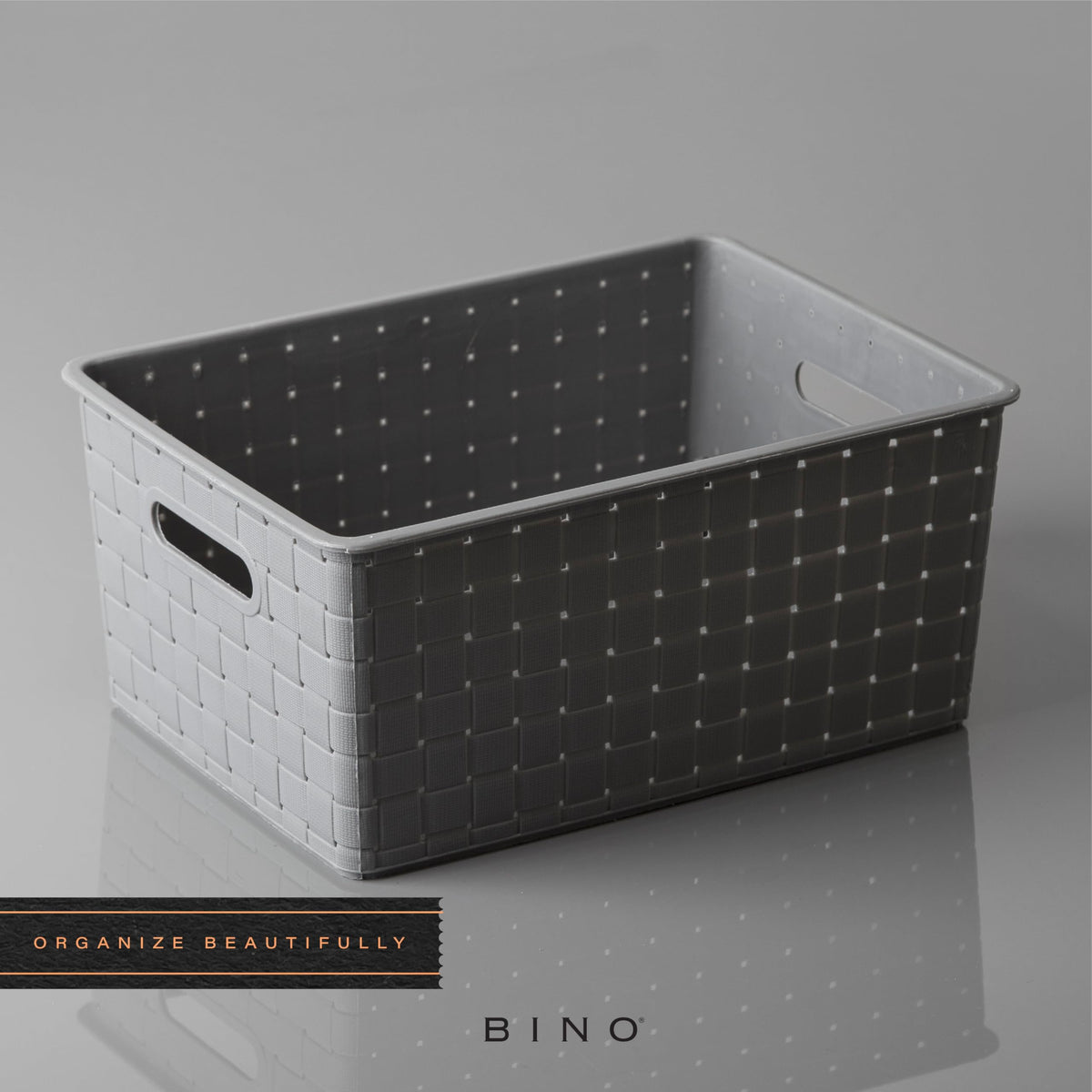 BINO medium grey basket on a shelf keeping desk items organized.